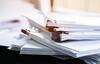 a close up of a stack of documents with clips 